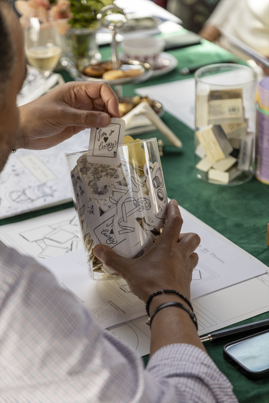 A guest choosing motifs from the atelier jars